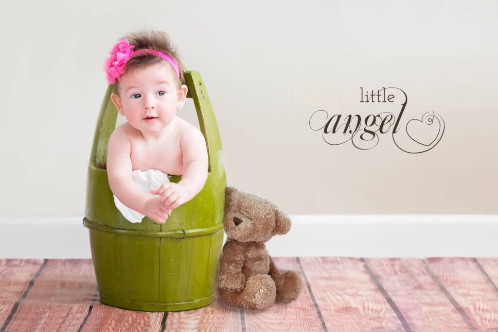 baby in a green bucket with bear toy