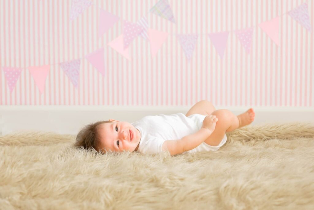 baby laying down on fur rug