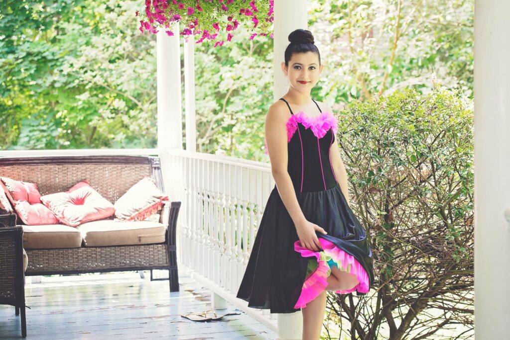 girl dressed up for recital standing on the porch