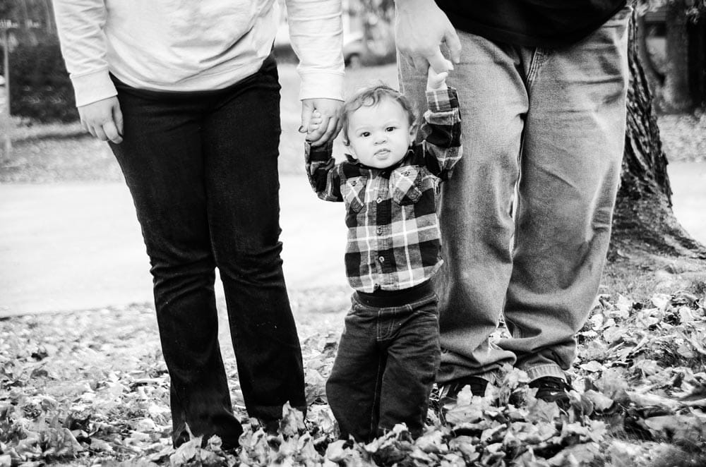 Baby boy being held by parents