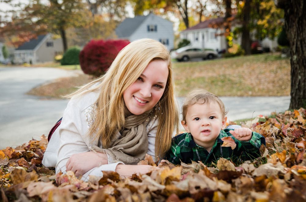 Mom and baby laying down on the grass