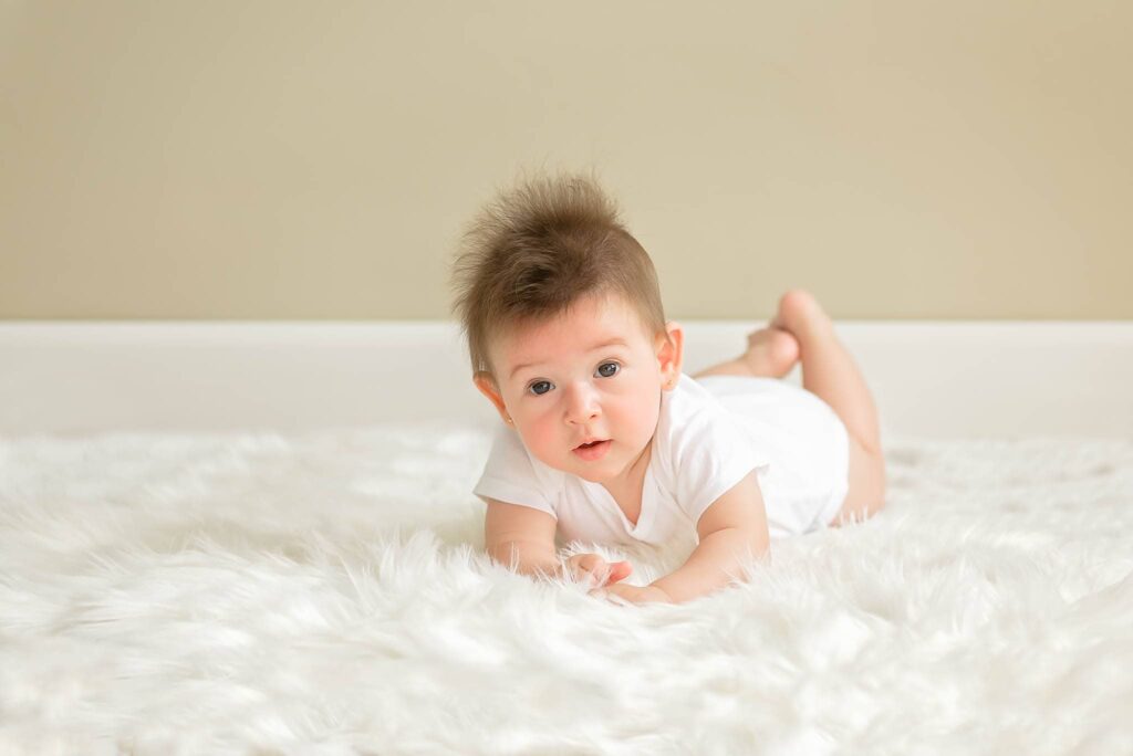baby girl laying down on the floor