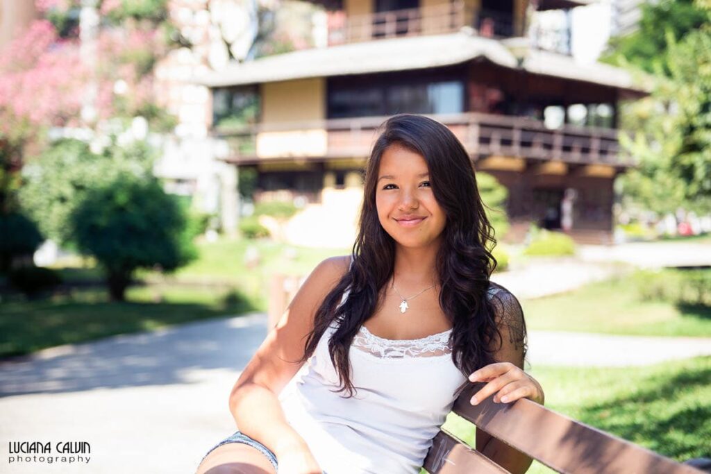 Teen seating on a bench at Praca do Japao in Curitiba Brazil