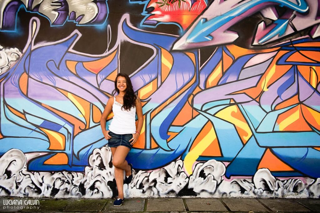 Teen on in front of a graffiti wall in Curitiba Brazil