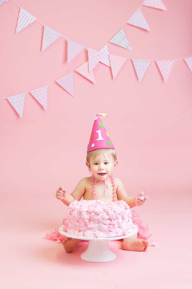 baby with pink cake