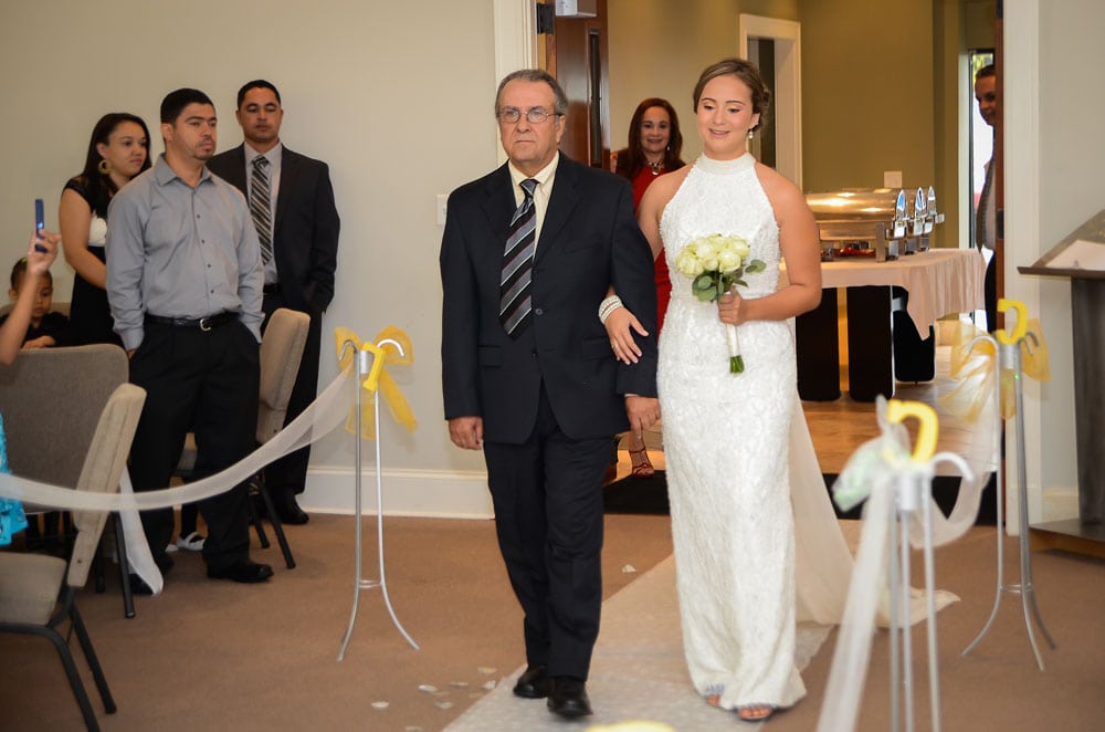 bride walking with father on the idle