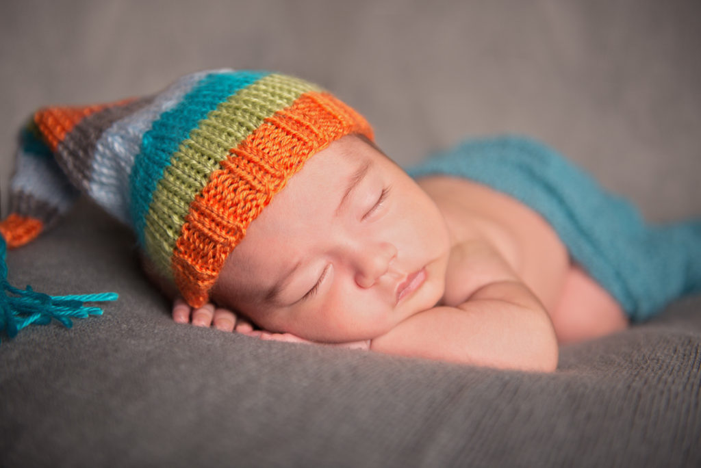 newborn baby sleeping with a colorful hat newborn baby sleeping with a colorful hat