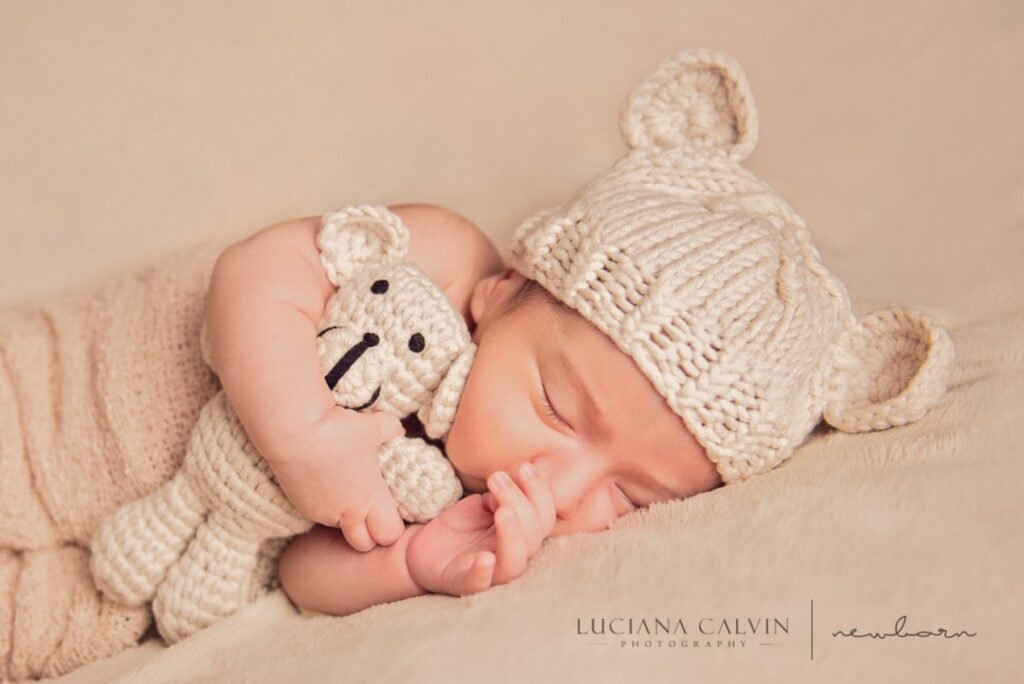 newborn sleeping with a little stuffed animal newborn sleeping with a little stuffed animal