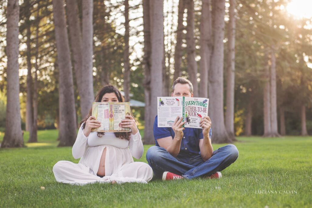 pregnant couple reading maternity books