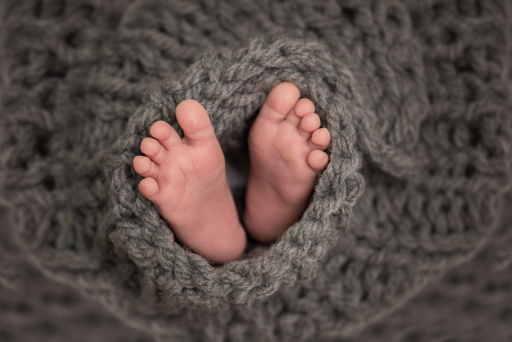 newborn feet wrapped in a blanket