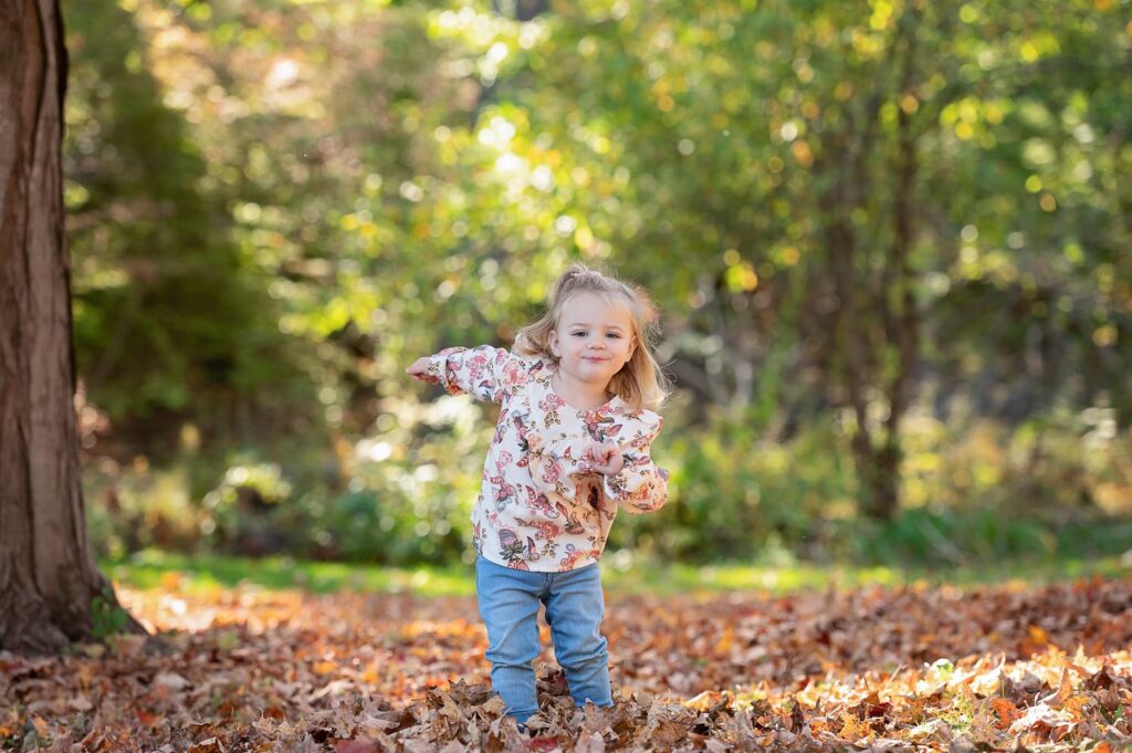 a child standing in leaves