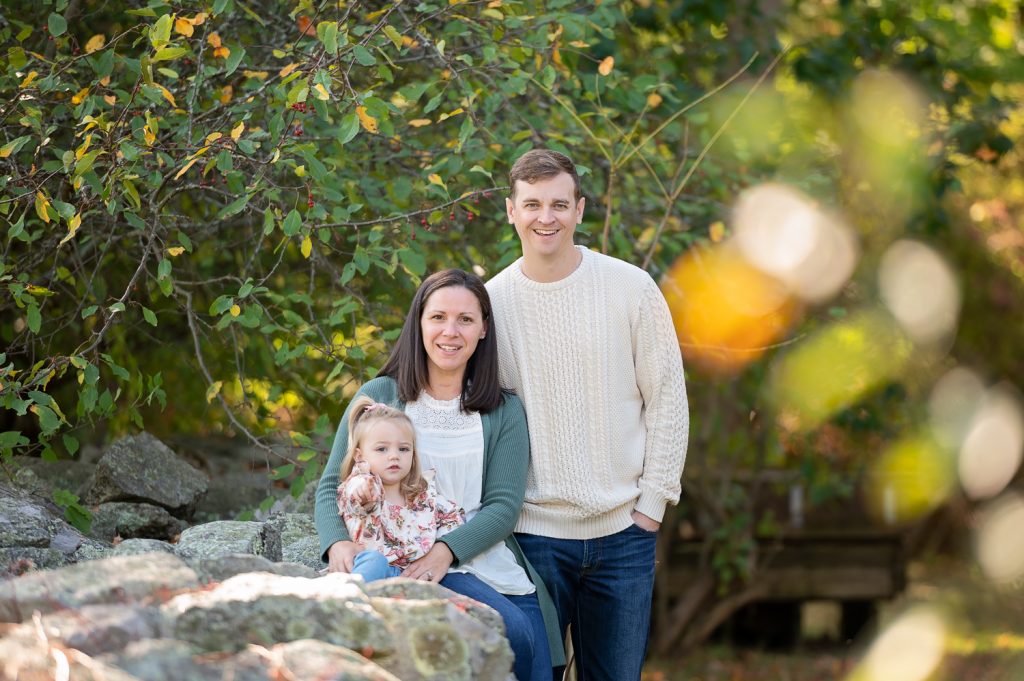 a man and woman with a child posing for a picture