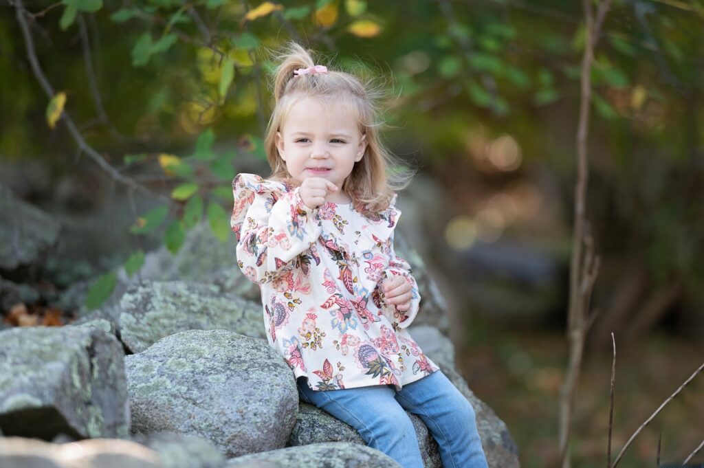 a girl sitting on a rock