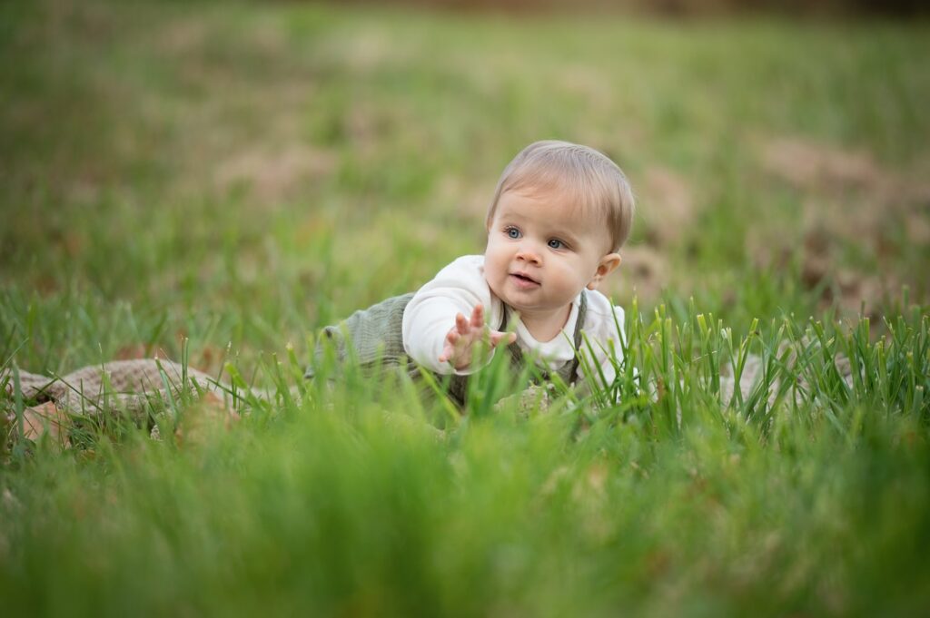 a baby crawling in the grass