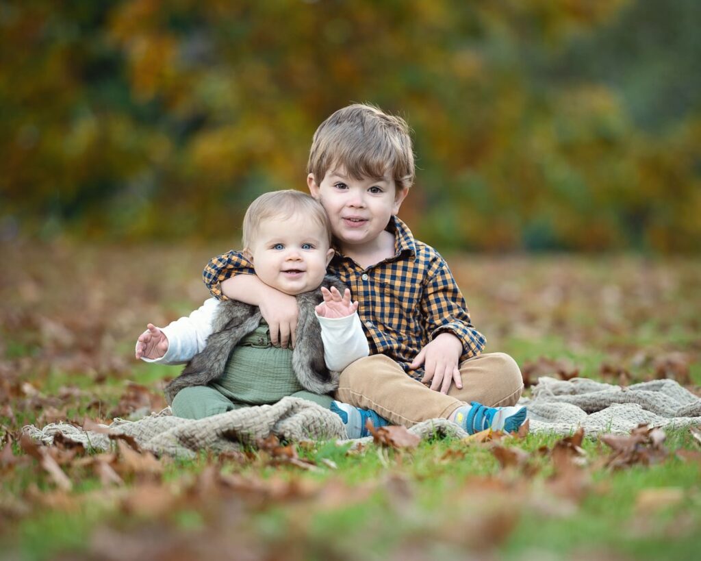 two children sitting on the ground