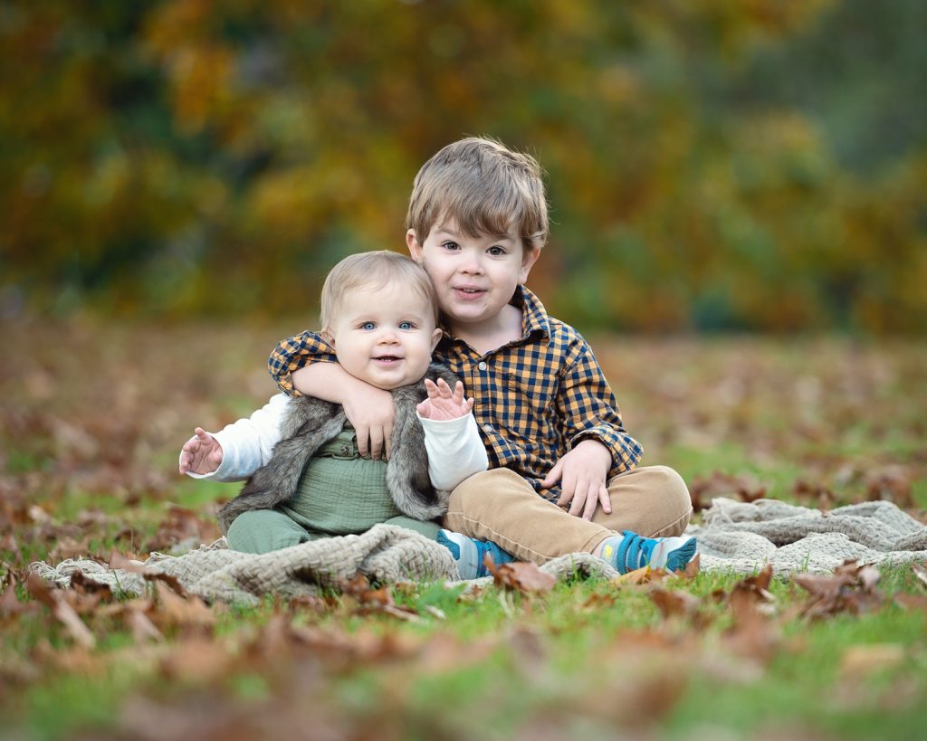 two children sitting on the ground