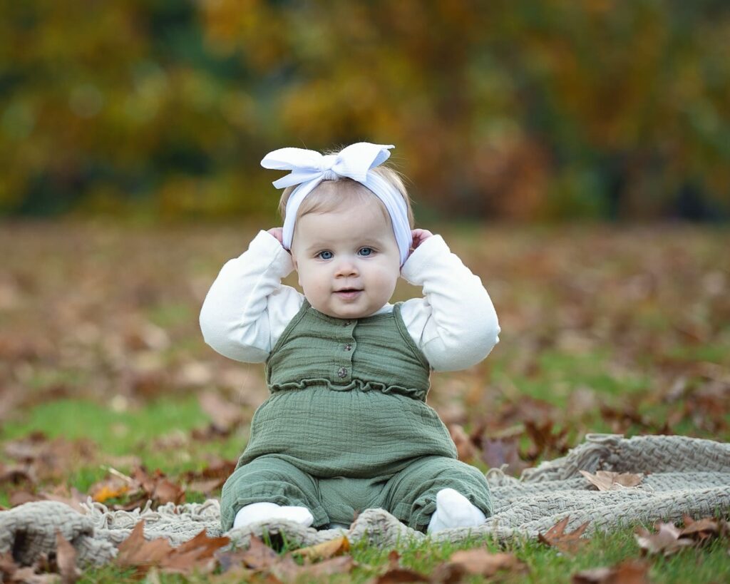 a baby sitting on the ground