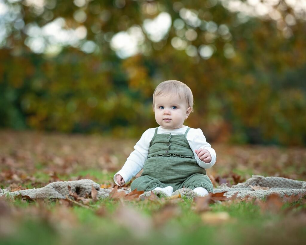 a baby sitting on the ground