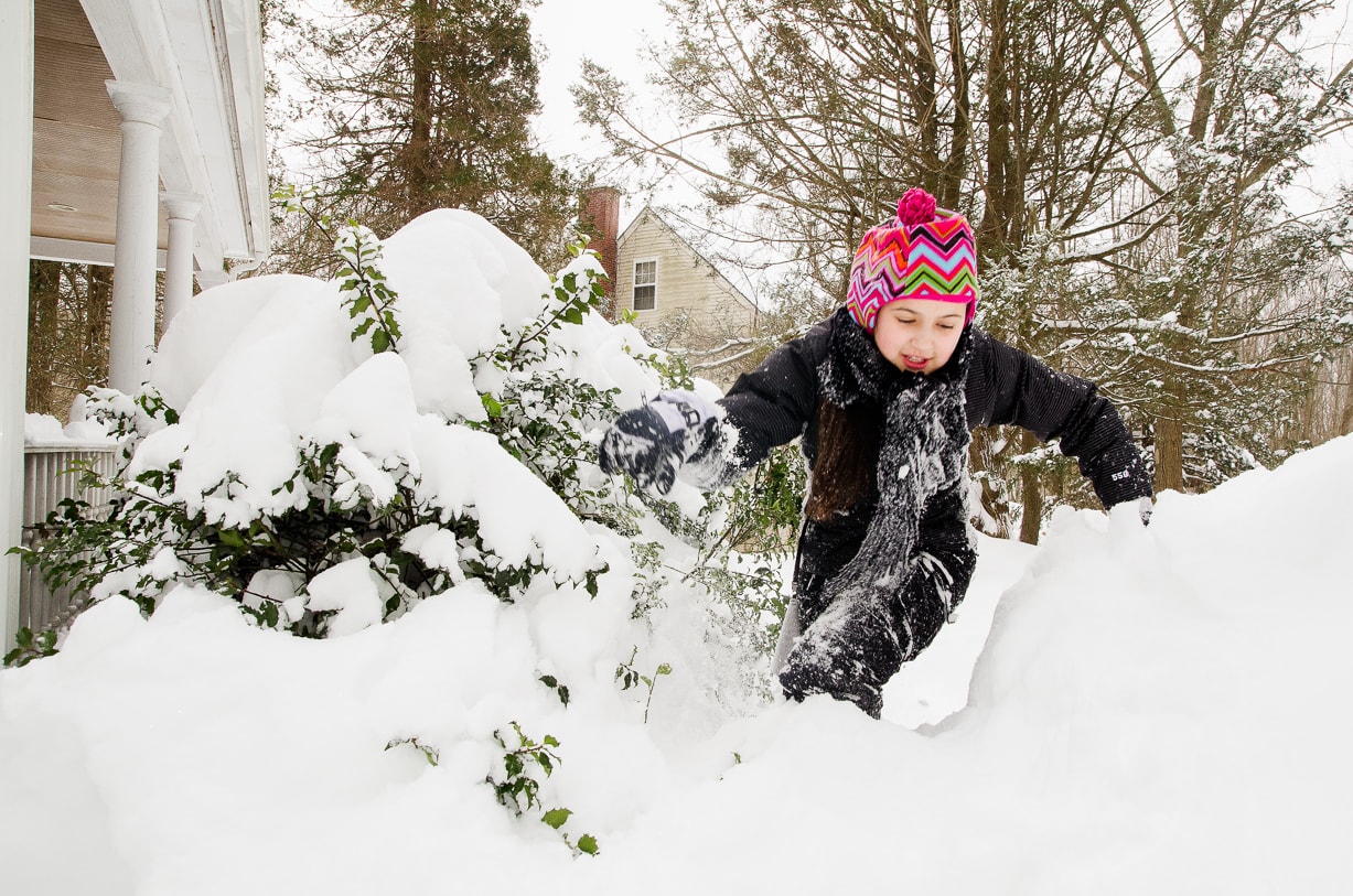girl playing in snow